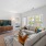 a living room with a large tv and a couch