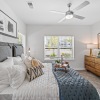 a bedroom with a bed, a dresser and a window