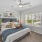 a bedroom with a bed and a ceiling fan
