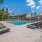 a swimming pool with lounge chairs around it