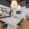 a clubhouse kitchen with a bar and stools