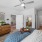 a bedroom with a bed and a fan