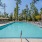 a swimming pool with trees in the background